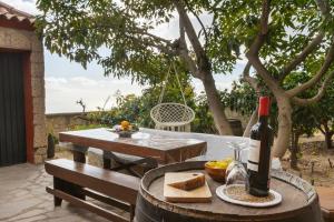 a table with a bottle of wine and bread on it at Mountain Getaway for Hikers 1 in Arafo +18 photos