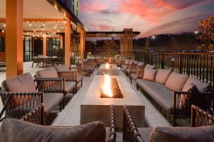 an outdoor patio with couches and a fire pit at Hilton Garden Inn Knoxville Papermill Drive, Tn in Knoxville