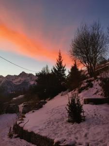 una colina cubierta de nieve con árboles y una puesta de sol en La Maison del Ru - CIR VDA GIGNOD 0037, en Gignod