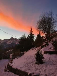 a snow covered hill with trees and a sunset at La Maison del Ru - CIR VDA GIGNOD 0037 in Gignod +27 photos