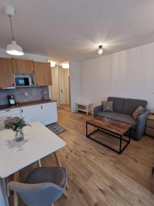 a living room with a couch and a table at Apartmán 111 Vila Zuberec in Zuberec