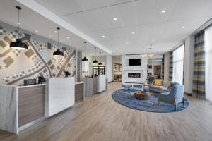 a lobby of a building with a living room at Homewood Suites by Hilton Boston Woburn in Woburn