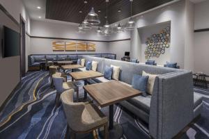 a row of tables and couches in a restaurant at Homewood Suites by Hilton Boston Woburn in Woburn +26 photos