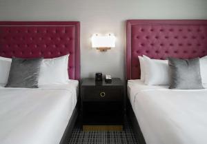 A bed or beds in a room at The Axis Moline Hotel, Tapestry Collection By Hilton