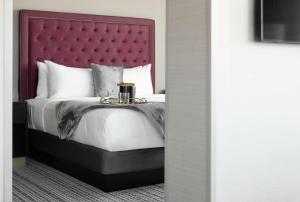 A bed or beds in a room at The Axis Moline Hotel, Tapestry Collection By Hilton