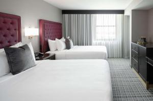 A bed or beds in a room at The Axis Moline Hotel, Tapestry Collection By Hilton