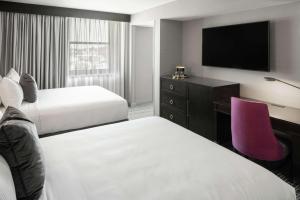 A bed or beds in a room at The Axis Moline Hotel, Tapestry Collection By Hilton