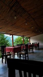 a group of tables and chairs in a restaurant at Bujtina Te Grima in Theth
