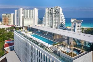 - un bâtiment avec une piscine en haut dans l'établissement Canopy By Hilton Cancun La Isla, à Cancún