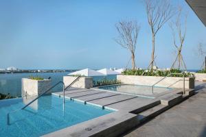 a swimming pool with a view of the water at Canopy By Hilton Cancun La Isla in Cancún