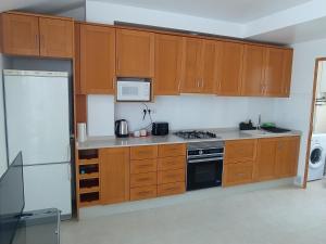 a kitchen with wooden cabinets and a stove top oven at ÁTICO CENTRO in Yecla