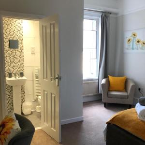 a bedroom with a door leading to a bathroom at Comfy big 7 bedroom townhouse in Harrogate
