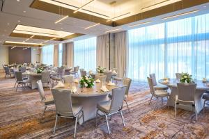 a conference room with tables and chairs and large windows at Canopy West Palm Beach - Downtown in West Palm Beach +56 photos
