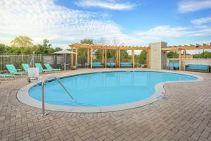 肯尼索的住宿－Tru By Hilton Kennesaw, Ga，一个带椅子和凉亭的大型游泳池
