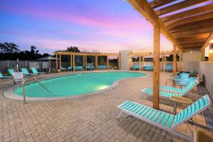 a swimming pool with lounge chairs and a pavilion at Tru By Hilton Kennesaw, Ga in Kennesaw