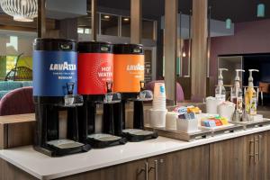 a counter with a bunch of products on it at Tru By Hilton Charlotte Airport Lake Pointe in Charlotte