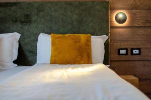 Postel nebo postele na pokoji v ubytování Suàn Hotel
