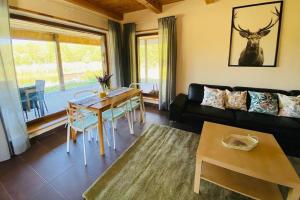 a living room with a couch and a table at Forest springs. Family vacation tennis beach sauna in GratiÅ¡kÄ—s