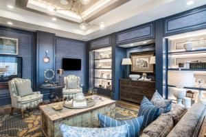 a living room with blue walls and a couch at Homewood Suites By Hilton Salina/Downtown, Ks in Salina