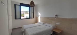 a room with two beds and a window at Casa Rural Reserva de las Nieves in Tolox +21 photos