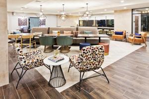 a lobby with a table and chairs and a dining room at Home2 Suites By Hilton Alpharetta, Ga in Alpharetta