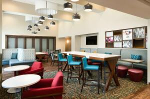 a waiting room with tables and chairs at Hampton Inn Clewiston in Clewiston