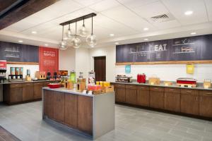 a fast food restaurant with wooden cabinets and a counter at Hampton Inn Clewiston in Clewiston