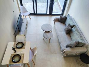 a living room with a couch and a table at Avramiou Loft Studio in Ágios Rókkos