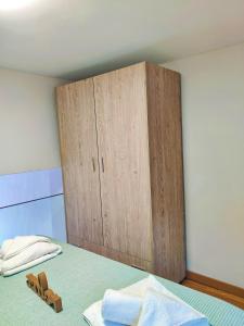 a bedroom with a wooden cabinet and a bed at Avramiou Loft Studio in Ágios Rókkos