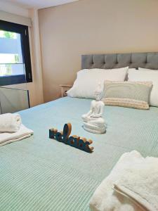 a buddha statue sitting on top of a bed at Avramiou Loft Studio in Ágios Rókkos