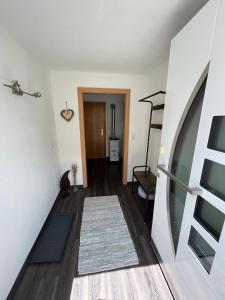 a hallway with a staircase leading to a living room at Ferienwohnung Schennach in Obsteig