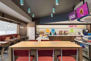 a fast food restaurant with tables and chairs at Tru By Hilton Albany Airport, Ny in Latham