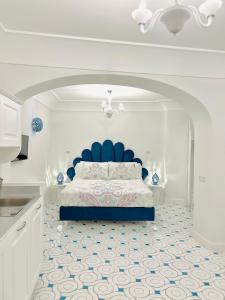 a bedroom with a bed with a blue head board at Villa Dei Principi in Positano +146 photos