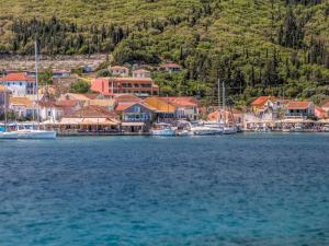 a small town on the shore of a body of water at Fiscardo Bay Hotel in Fiskardo