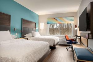 a hotel room with two beds and a window at Tru By Hilton Albany Airport, Ny in Latham