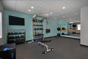 a room with a gym with weights and a tv at Tru By Hilton Monroe, MI in Monroe