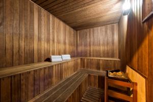 a wooden sauna with two white towels in it at INNSiDE by Meliá São Paulo ITAIM in Sao Paulo
