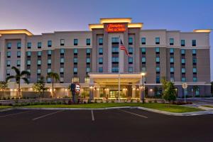 a hotel with a sign on the front of it at Hampton Inn & Suites Tampa Riverview in Tampa