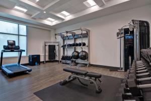 a room with a gym with a bench and weights at Hampton Inn & Suites Tampa Riverview in Tampa