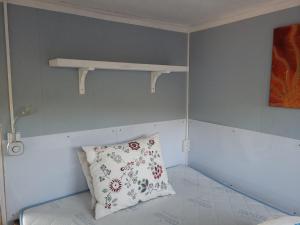 a small room with a pillow and a shelf at Ferienwohnung Kruppa in Rerik