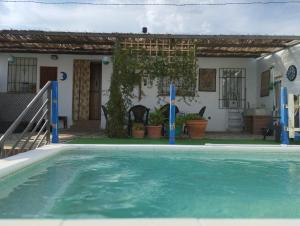 a swimming pool in front of a house at Casita Colibrí in La Puebla de Montalbán