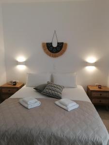 a bedroom with a bed with two towels on it at Zefyros Studios in Plaka