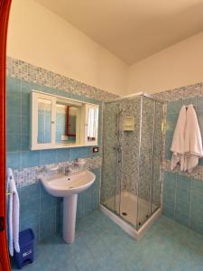 a bathroom with a sink and a shower at Aglaia in Torre Lapillo