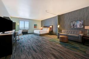 a hotel room with a bed and a couch at Home2 Suites By Hilton Atascadero, Ca in Atascadero