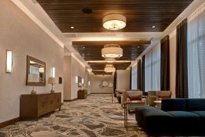 a lobby with a waiting room with couches and chairs at Hilton Garden Inn Summerville, Sc in Summerville