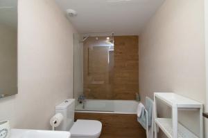 a bathroom with a toilet and a bath tub at THE SEA VIEW CALACEITE in Torrox Costa