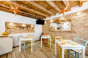 a dining room with white tables and chairs at B&B InCalle in Chioggia