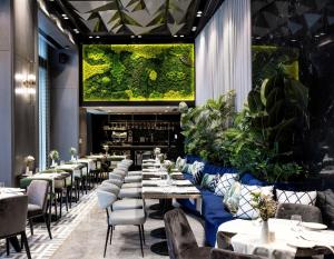 a restaurant with tables and chairs and a large aquarium at The Maestro Hotel in Istanbul