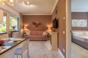 a living room with a bed and a room with a couch at Emerald Suites in Stresa