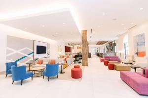 a waiting room with colorful chairs and tables at Hilton Garden Inn Winter Park, FL in Orlando